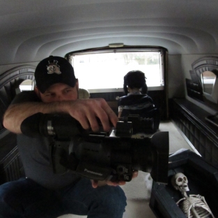 Brenton feeling oddly comfortable filming from the back of Cassandra's Hearse Mary